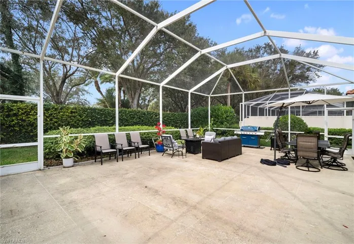 View of patio featuring screen enclosure, outdoor dining area, an outdoor hangout area, and a sunroom