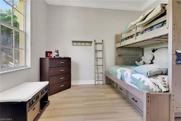 Bedroom featuring ornamental molding and light wood finished floors