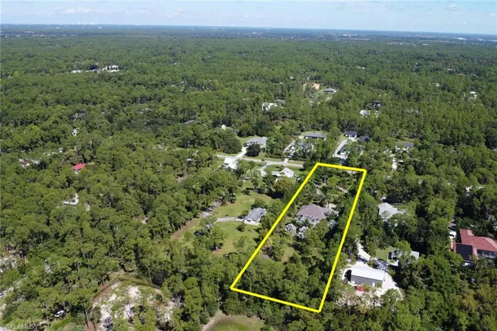 Aerial overview of property's location featuring property boundaries highlighted and a heavily wooded area