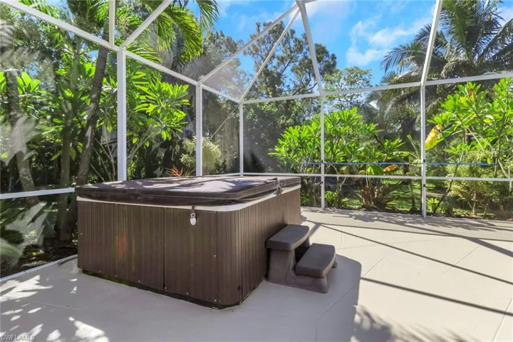 Sunroom / solarium featuring a jacuzzi