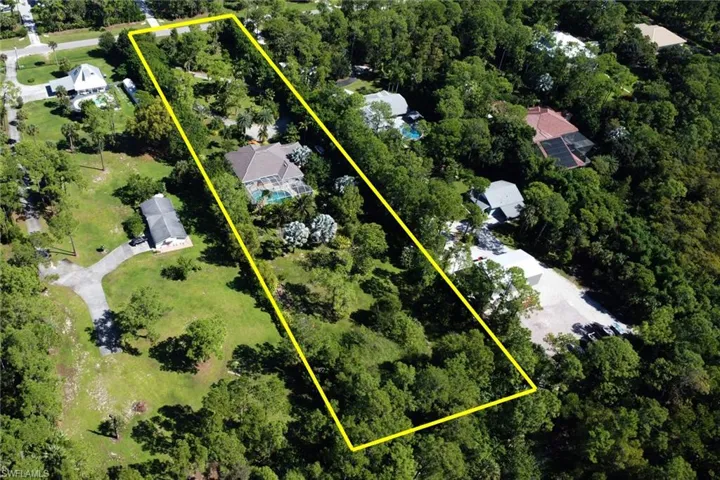 Aerial view of property and surrounding area with property parcel outlined