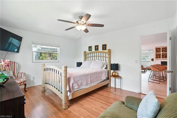 Bedroom featuring wood finished floors and a ceiling fan