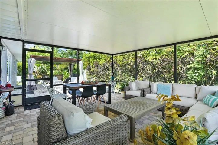 Sunroom with an outdoor hangout area and outdoor dining area