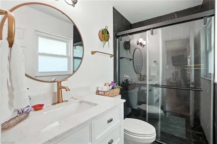 Bathroom featuring vanity and a shower stall