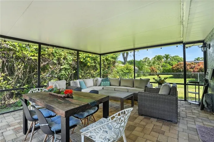 Sunroom with an outdoor living space and outdoor dining area