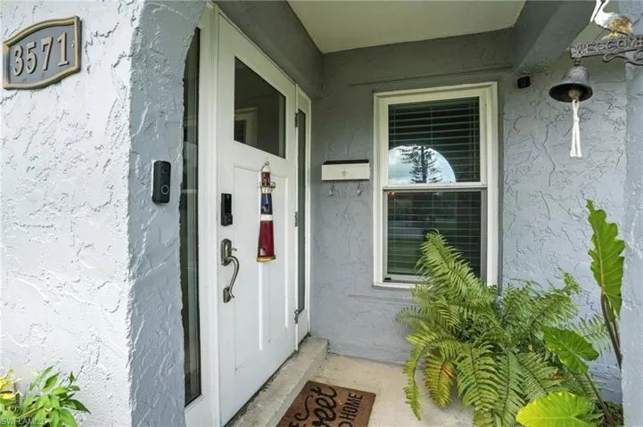 Property entrance featuring stucco siding