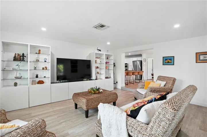 Living room featuring light wood finished floors and recessed lighting