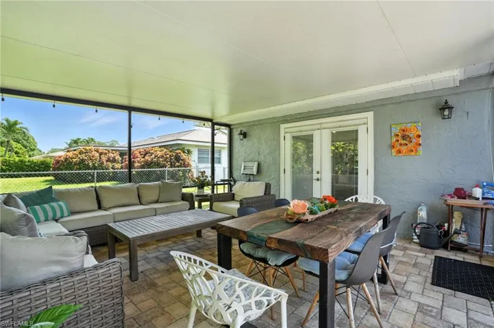 Sunroom / solarium featuring french doors, outdoor lounge area, and healthy amount of natural light