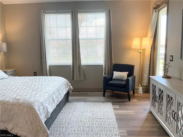 Primary bedroom overlooks the lake and opens to lanai area