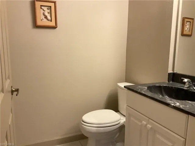 Guest Half-Bathroom with vanity, and toilet