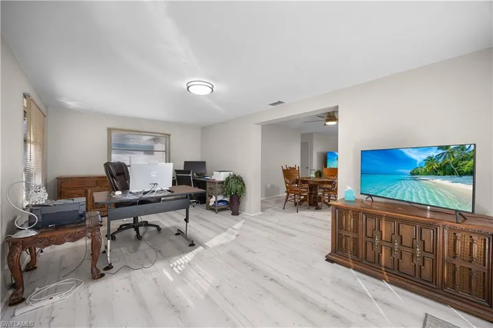 Office space with light wood-style flooring and ceiling fan