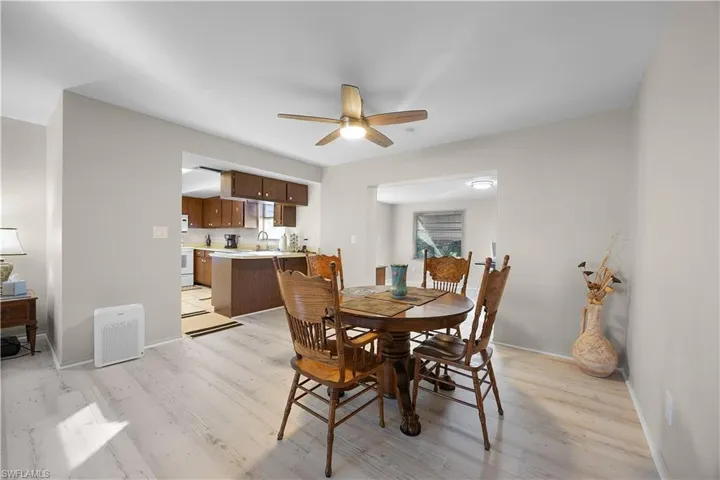 Dining space with light wood-style flooring and a ceiling fan