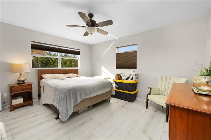 Bedroom with ceiling fan and light wood finished floors