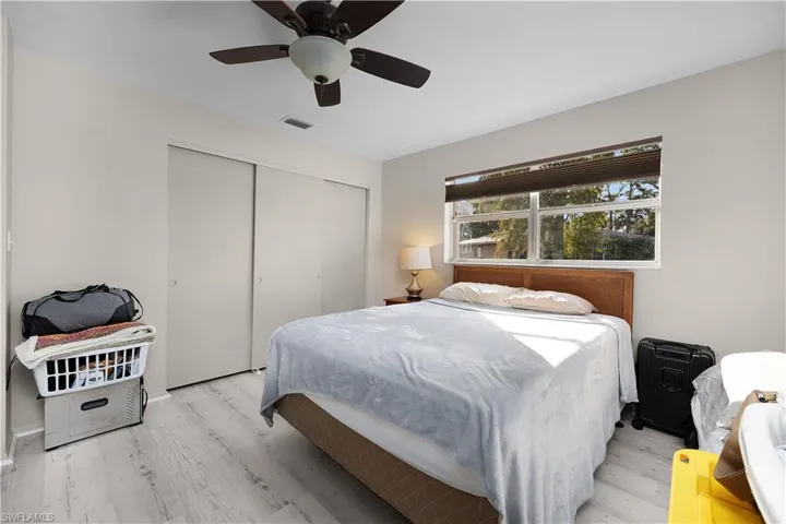 Bedroom featuring a ceiling fan, wood finished floors, and a closet