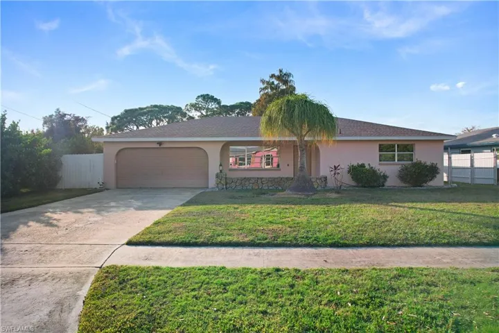 Single story home featuring stucco siding, concrete driveway, and a garage