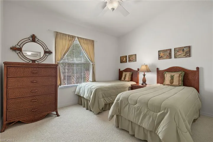 Bedroom featuring ceiling fan, carpet, and vaulted ceiling