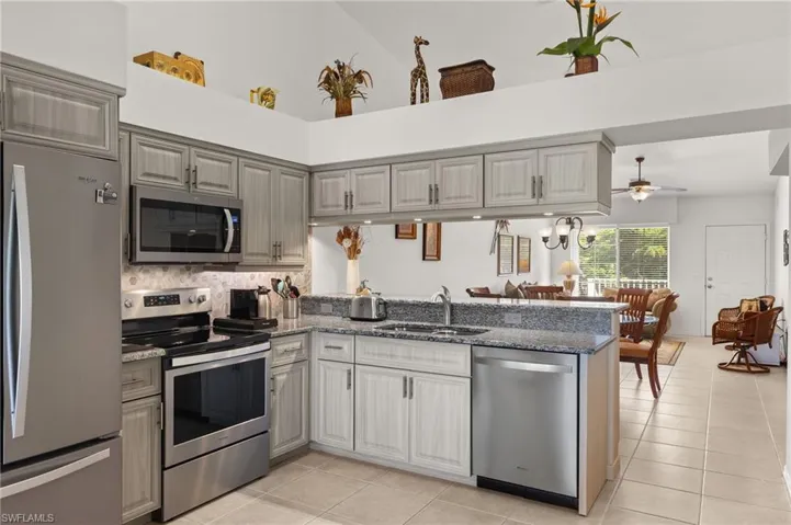 Kitchen featuring stainless steel appliances, kitchen peninsula, and sink
