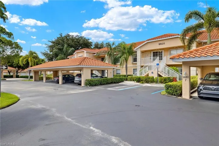 View of parking / parking lot featuring a carport