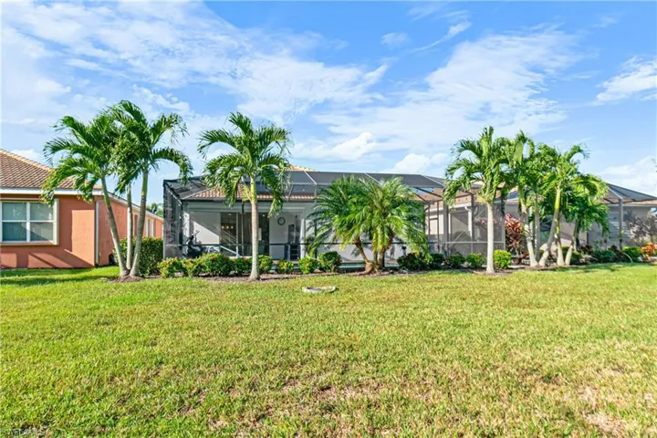 GREAT VIEW OF THE BACK OF THE HOME WITH ALL THE AMAZING FLORIDIAN LANDSCAPING THAT PROVIDES YOUR FUTURE HOME WITH THE DESIRED PRIVACY!
