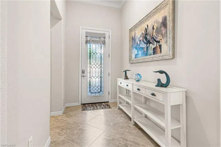 AMAZING FOYER WITH LUXURY TILE ON THE DIAGONAL. NOTE THE BEAUTIFUL FRONT ENTRY DOOR.