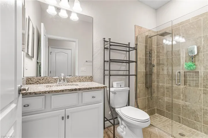 FULL GUEST BATHROOM WITH BEAUTIFULLY TILED GLASS WALK-IN SHOWER! YOUR FAMILY & FRIENDS WILL TRULY BE IMPRESSED! NOTE THE "RAINFALL SHOWER HEAD."