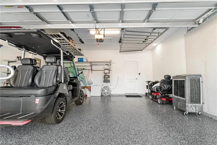 GARAGE HAS BEAUTIFUL EXPOXY COATING PLUS 2 DUAL MOTORIZED STORAGE RACKS LIFT SYSTEM!