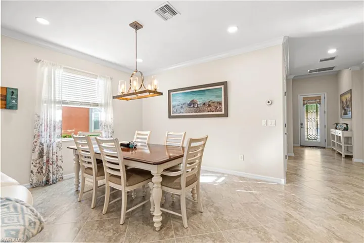 DINING AREA WITH CROWN MOLDING PLUS THE HOME HAS RECENTLY BEEN PROFESSIONALLY PAINTED! NOTE: MODERN & SIMPLY BEAUTIFUL CHANDELIER WAS INSTALLED ABOVE THE DINING ROOM TABLE!