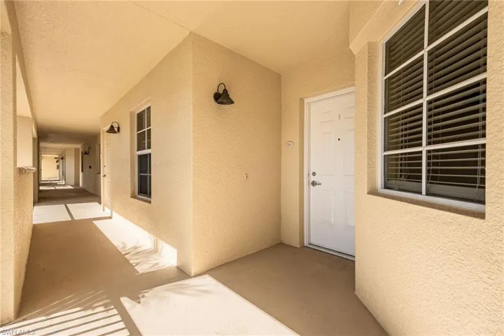 View of exterior entry with stucco siding