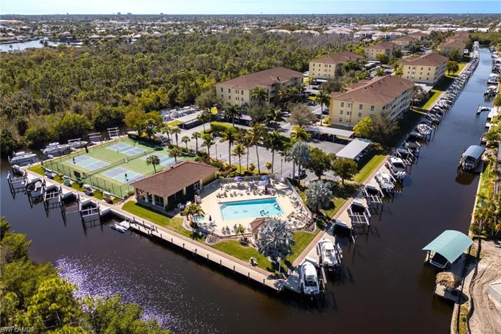 Aerial view of property and surrounding area with a nearby body of water