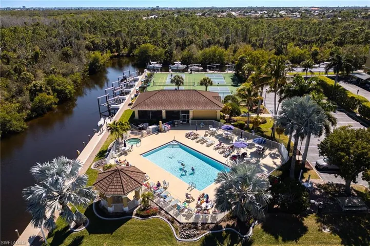 Bird's eye view of a nearby body of water and a pool