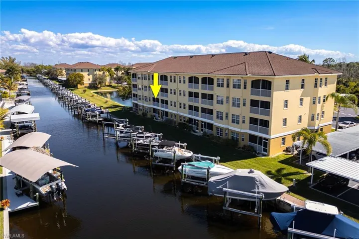 Dock area featuring boat lift and a water view