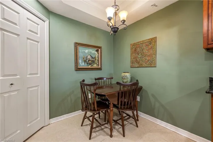 Dining space with hanging lights and a raised ceiling