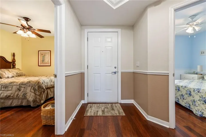 Foyer featuring a ceiling fan and dark wood-style floors