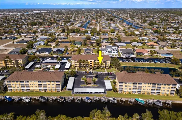 Aerial view of property and surrounding area featuring a nearby body of water