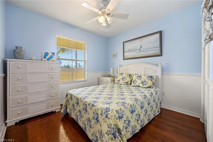 Bedroom featuring dark wood-style flooring and a ceiling fan