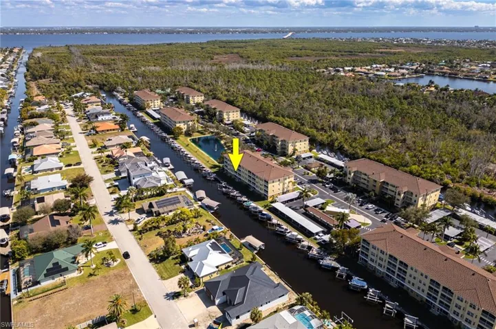View of property location with a large body of water and nearby suburban area