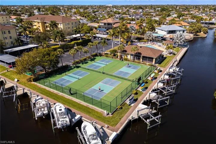 Aerial view of residential area featuring a nearby body of water