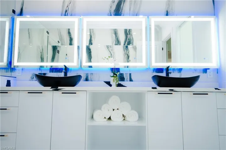 Bathroom featuring tasteful backsplash and vanity