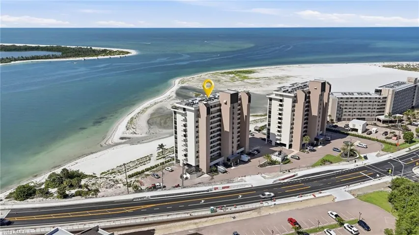 Aerial perspective showcasing multi-story residential buildings situated along a coastline - Virtually Edited Image