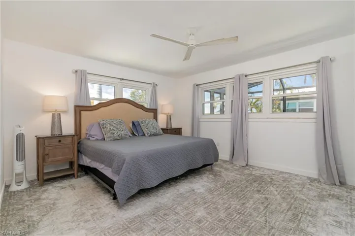 Bedroom with a ceiling fan and baseboards