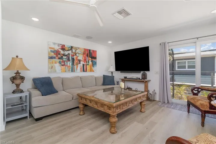 Living area featuring a ceiling fan, light wood-style floors, and recessed lighting