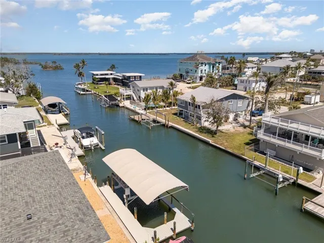 Aerial view of residential area featuring a nearby body of water