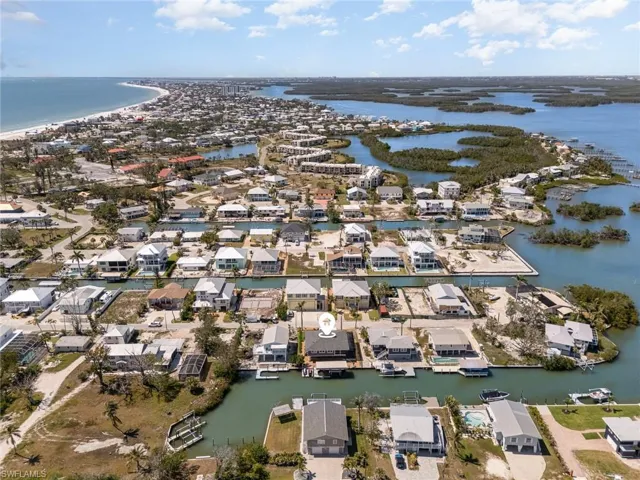 Aerial view of property's location with a large body of water and nearby suburban area