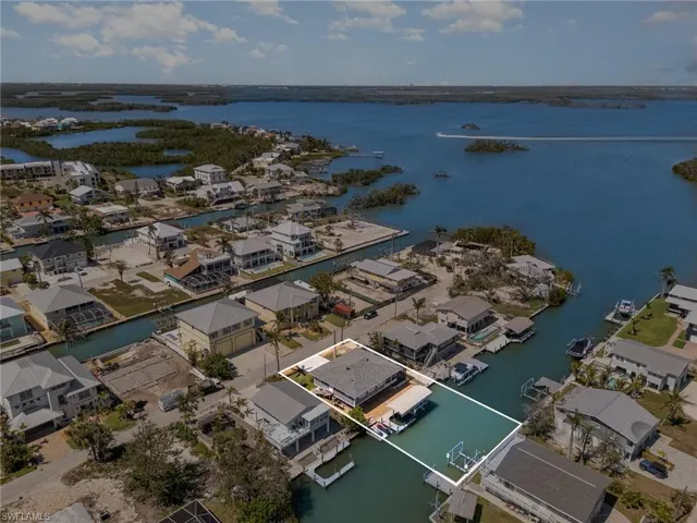Aerial perspective of suburban area with a nearby body of water