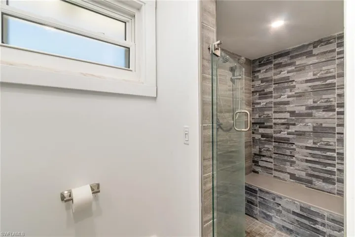 Full bathroom with a shower stall