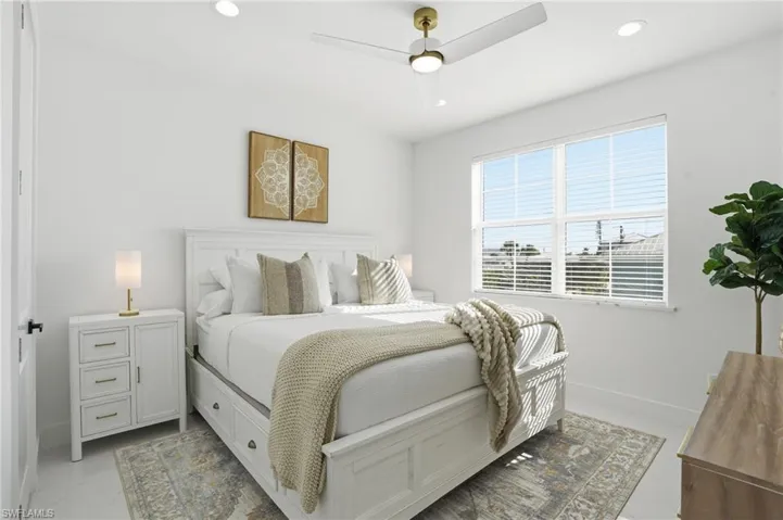 Bedroom with a ceiling fan and recessed lighting