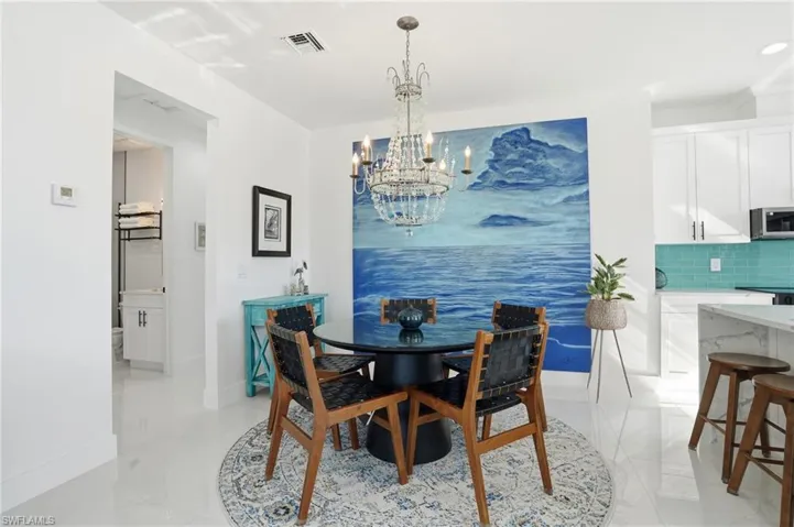 Dining area with a chandelier and baseboards