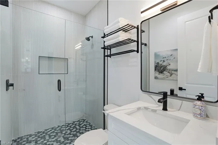 Full bathroom with vanity and a shower stall