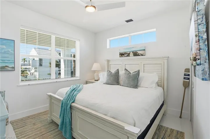 Bedroom with a ceiling fan and baseboards