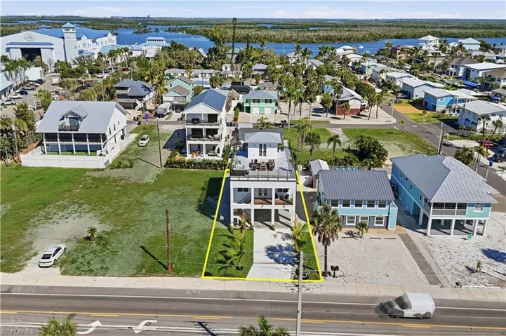 Aerial view of residential area featuring a nearby body of water